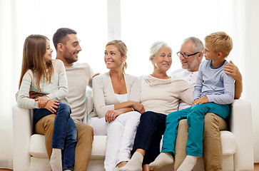 Image showing happy family sitting on couch at home