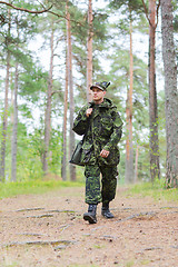 Image showing young soldier or hunter with gun in forest