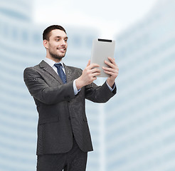 Image showing smiling buisnessman with tablet pc computer