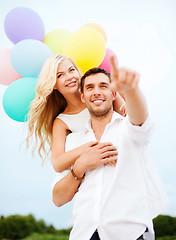 Image showing couple with colorful balloons at sea side