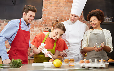 Image showing happy friends and chef cook baking in kitchen