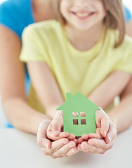 Image showing close up of woman and girl hands with paper house