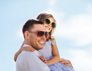 Image showing happy father and child in sunglasses over blue sky