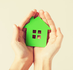 Image showing hands holding green house