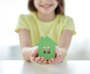 Image showing close up of happy girl hands holding paper house