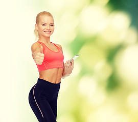 Image showing smiling sporty woman with smartphone