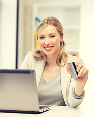 Image showing happy woman with laptop computer and credit card