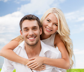 Image showing couple having fun over sky and grass background