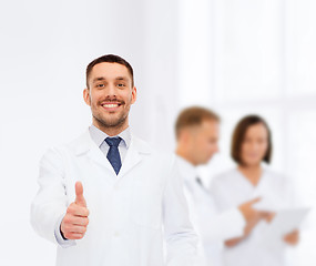 Image showing smiling male doctor showing thumbs up