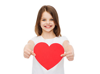 Image showing smiling little girl giving red heart