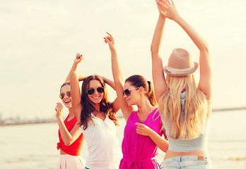 Image showing group of smiling women dancing on beach