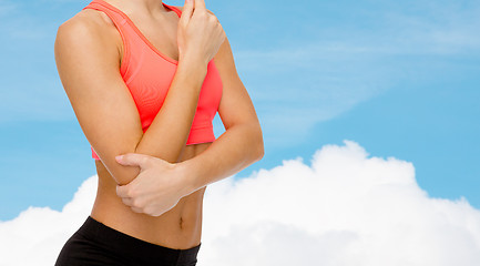 Image showing sporty woman with pain in elbow