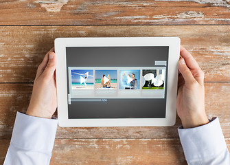 Image showing close up of hands with video gallery on tablet pc