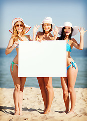 Image showing girls with blank board on the beach