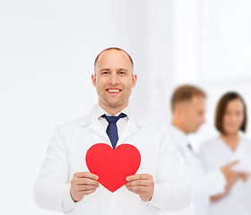 Image showing smiling male doctor with red heart