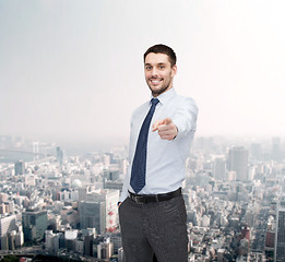 Image showing handsome businessman pointing finger at you