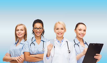 Image showing smiling female doctor and nurses with stethoscope