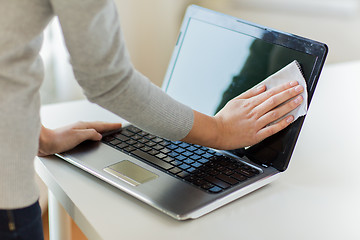 Image showing close up of woman hands cleaning laptop screen