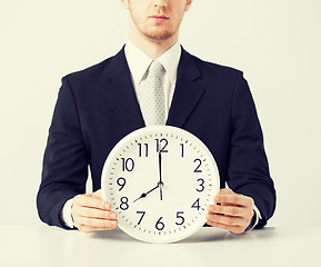 Image showing man with wall clock