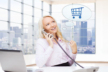 Image showing smiling businesswoman calling on telephone