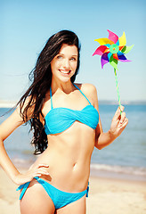 Image showing girl with windmill toy on the beach