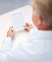 Image showing close up of old man holding blank photo frame
