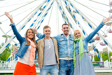 Image showing group of smiling friends waving hands