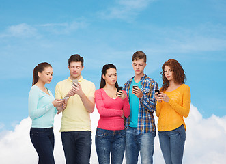 Image showing group of serious teenagers with smartphones