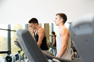 Image showing group of men exercising on treadmill in gym