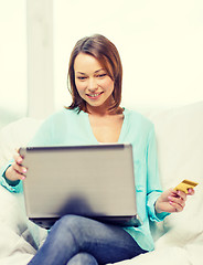 Image showing smiling woman with laptop computer at home