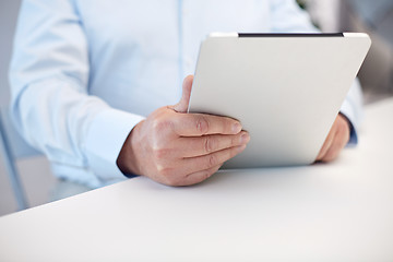 Image showing close up of senior man hands with tablet pc