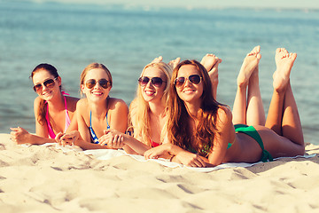 Image showing group of smiling women in sunglasses on beach