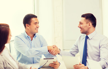 Image showing business team working with tablet pc in office