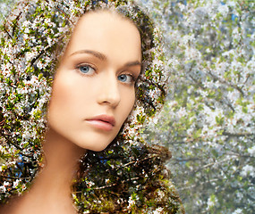 Image showing young woman over blooming tree pattern