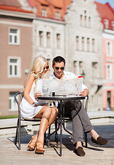 Image showing couple with map in cafe