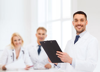 Image showing smiling male doctor with clipboard