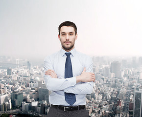 Image showing handsome businessman with crossed arms