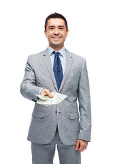 Image showing smiling businessman with american dollar money