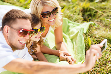 Image showing happy family with camera taking picture