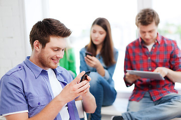 Image showing student looking into smartphone at school