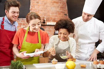 Image showing happy friends and chef cook baking in kitchen