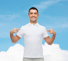 Image showing smiling man in t-shirt pointing fingers on himself