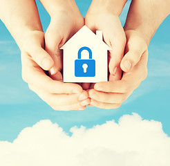 Image showing hands holding paper house with lock