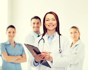 Image showing smiling female doctor with clipboard