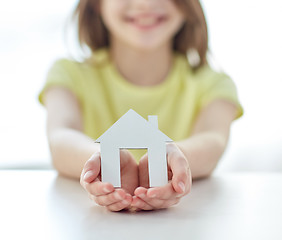 Image showing close up of happy girl hands holding paper house