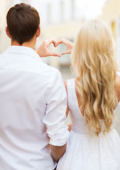 Image showing romantic couple in the city making heart shape