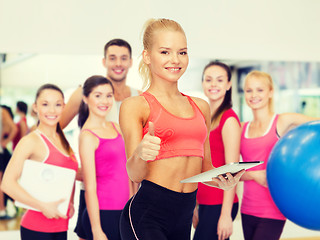 Image showing smiling sporty woman with tablet pc computer