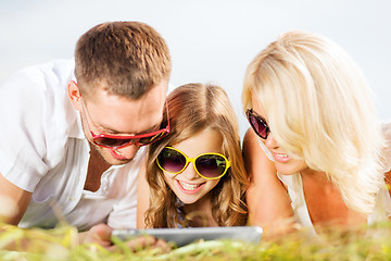 Image showing happy family with tablet pc taking picture