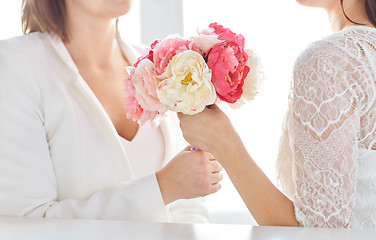 Image showing close up of happy lesbian couple with flowers