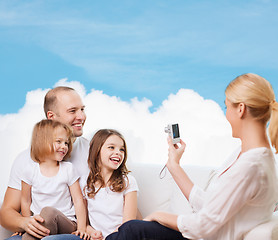 Image showing happy family with camera at home